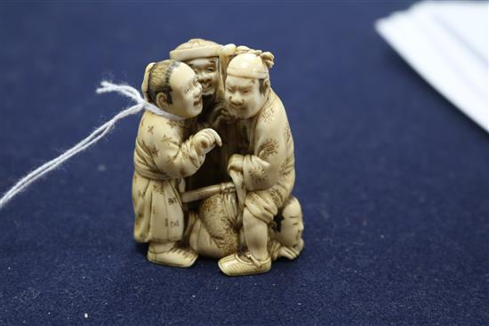 A Japanese ivory okimono carved with three figures height 6.5cm